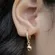 Brinco Argola Articulada Cravejada com Zircônias e Pingente de Bola Lisa - Banhada a Ouro 18k