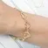 Pulseira com Pingente de Corações Vazados e Lisos Banhado a Ouro 18k
