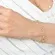 Pulseira com Pingente de Corações Vazados e Lisos Banhado a Ouro 18k