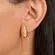 Brinco Grande com Base Oval em Chapa Lisa e Pingente Oval Vazado Banhado a Ouro 18k