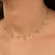Choker com Pingentes de Olho Grego e Cristais Redondos Intercalados  Banhado a Ouro 18k