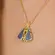 Colar com Pingente de Nossa Senhora Banhado a Ouro 18k – 2 em 1, com Zircônias Azuis e Cristais
