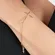 Pulseira Crucifixo Liso Horizontal Banhada a Ouro 18 k